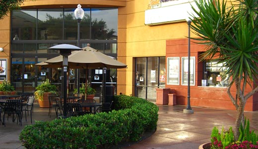 An image depicting store front and entrance way of a retails shopping center